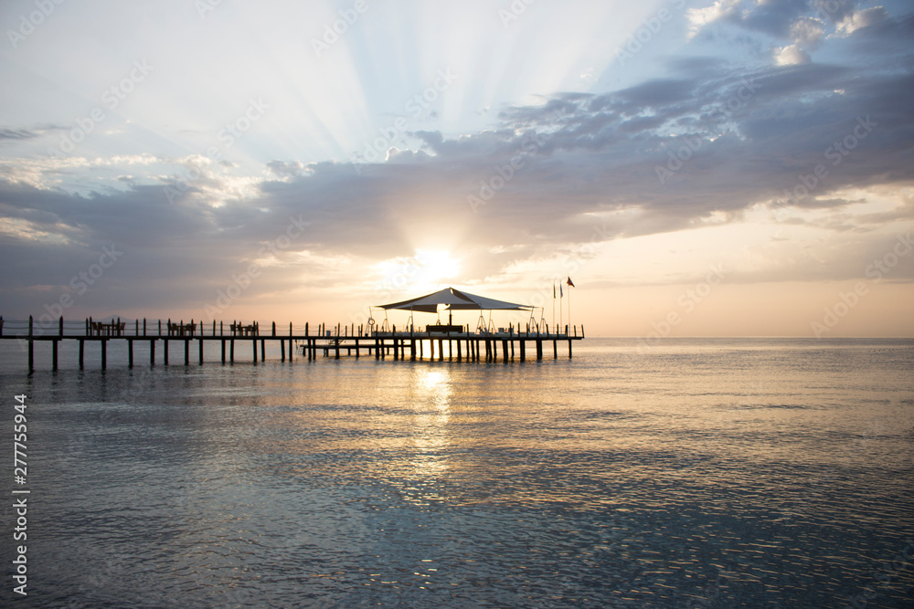 Pier in the azure sea during the dawn.