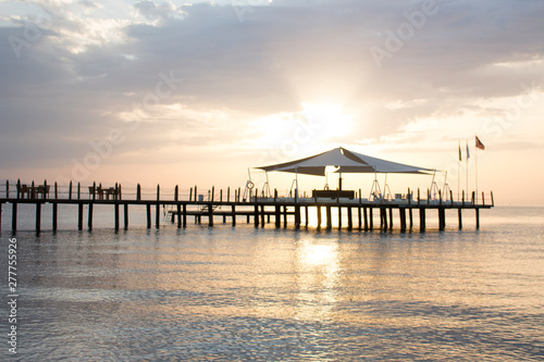 Pier in the azure sea during the dawn.