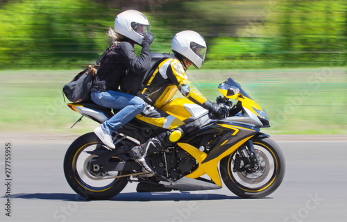 Active couple riding on the motorbike  slow motion  having fun in bikers tour  happy adventure concept on spring road