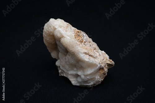 Calc-sinter white and rare gemstone formed on an usual piece of bed rock