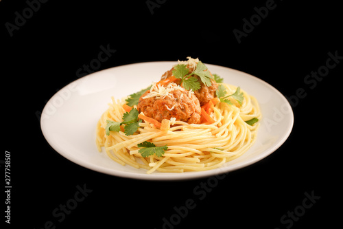 meatballs with pasta on a black background. Delicious meatballs decorated with herbs