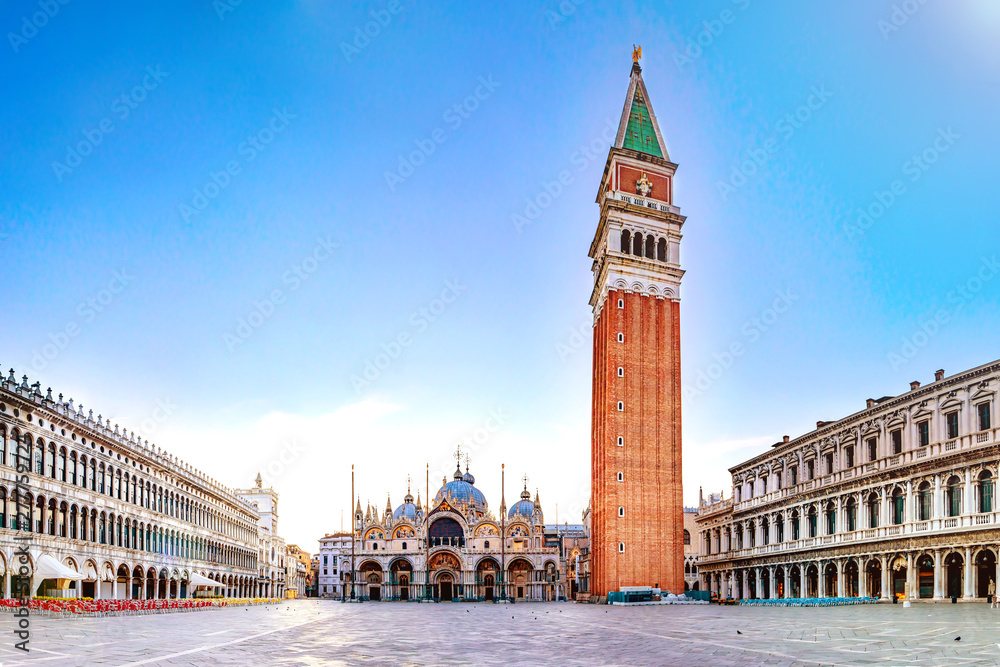 Sunrise in San Marco square with Campanile and San Marco's Basilica. Panorama of the main square of the Old town. Venice, Veneto, Italy.