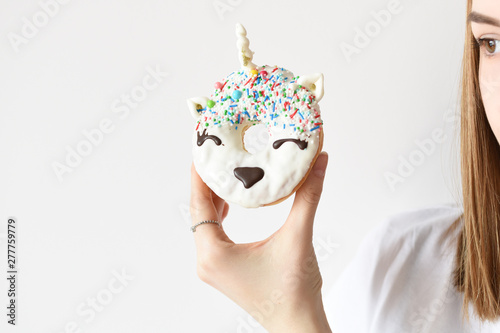 Fototapeta Naklejka Na Ścianę i Meble -  Unicorn donut in female hand