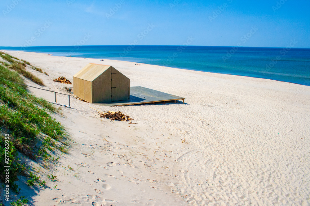 Obraz premium Beautiful sandy beach with dunes in Nida - Curonian Spit and Baltic Sea, Nida, Klaipeda, Lithuania, Unesco heritage with wooden house on the shore