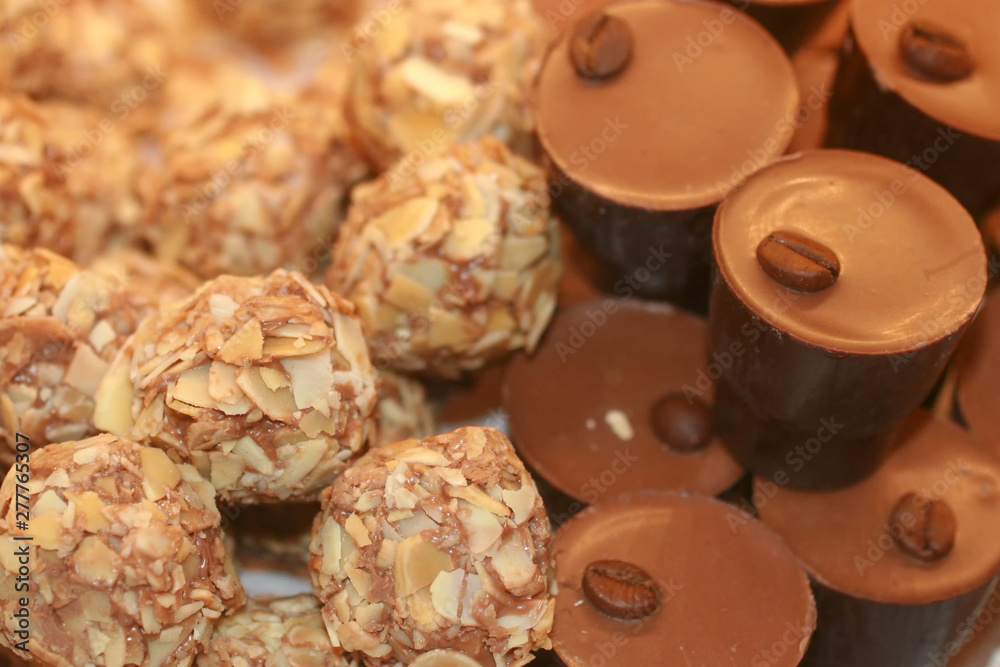 Chocolates with nuts. Texture of candy. Confectionery.