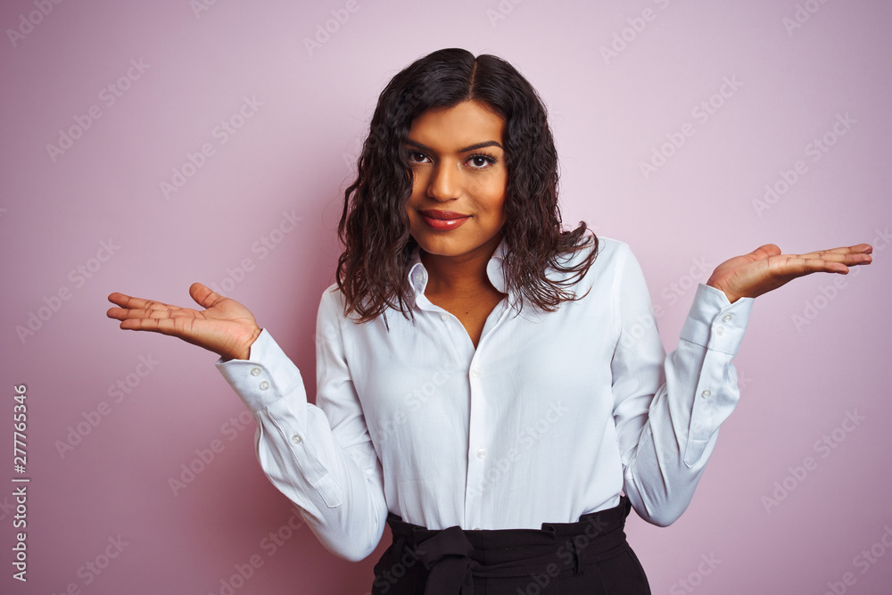 Beautiful transsexual transgender elegant businesswoman over isolated pink background clueless and confused expression with arms and hands raised. Doubt concept. Beautiful transsexual transgender elegant businesswoman over isolated pink background clueless and confused expression with arms and hands raised. Doubt concept.