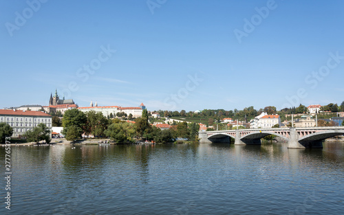 Panoramic view of Vltava river  Prague castle  and colorful rooftops of New Town on a bright summer day  in Prague  Czech Republic