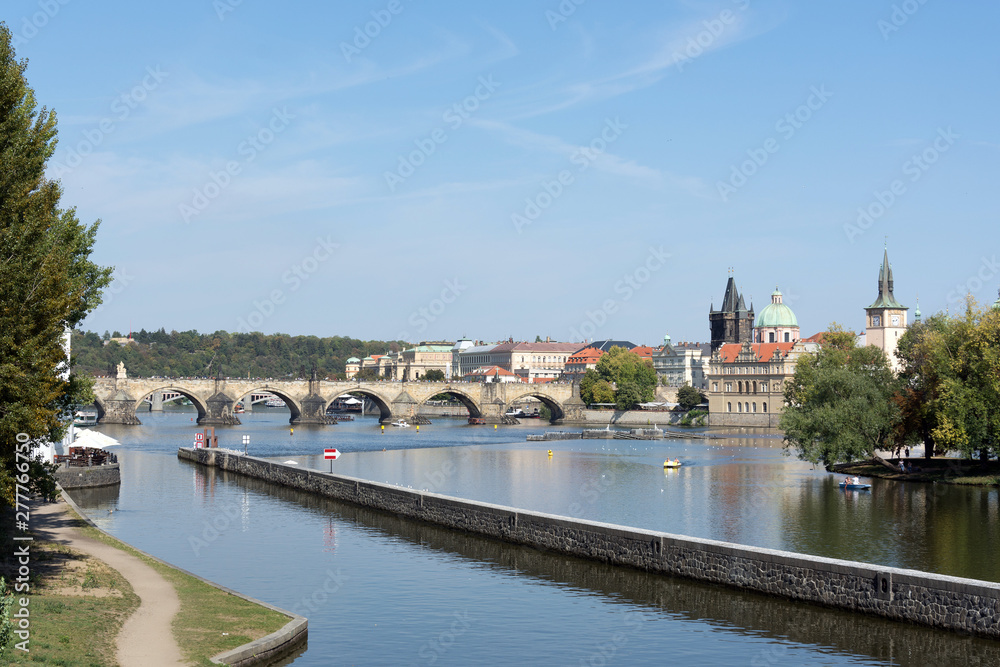 Panoramic view of Vltava river and Charles bridge on a bright summer day, in Prague, Czech Republic