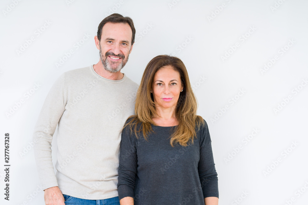 Beautiful middle age couple in love over isolated background Relaxed with serious expression on face. Simple and natural looking at the camera. Beautiful middle age couple in love over isolated background Relaxed with serious expression on face. Simple and natural looking at the camera.