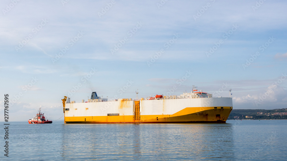 Container ship tossed by tossing boat