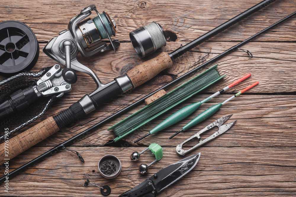 Fishing tackle for fishing peaceful fish. Float, fishing rod, reel, fishing  line on the wooden background Stock Photo