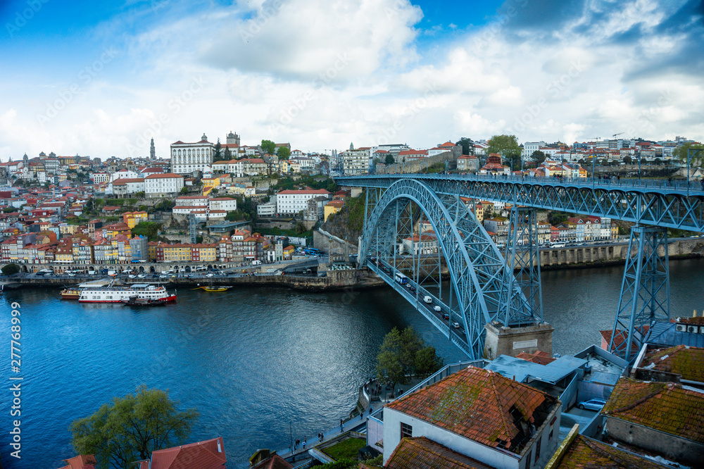 Oporto or Porto city skyline, Douro river, traditional boats and Dom Luis or Luiz iron bridge. Portugal, Europe.
