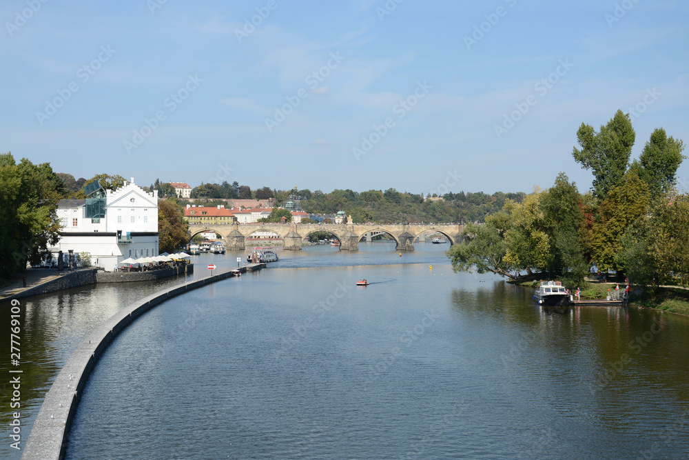 Panoramic view of Vltava river and Charles bridge on a bright summer day, in Prague, Czech Republic