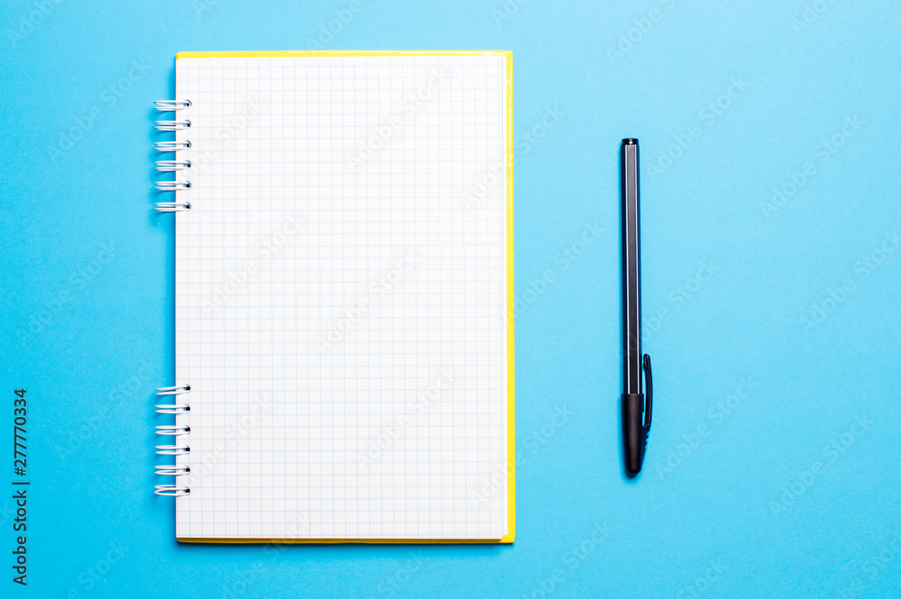 notebook on a blue background with pens - obrazy, fototapety, plakaty 