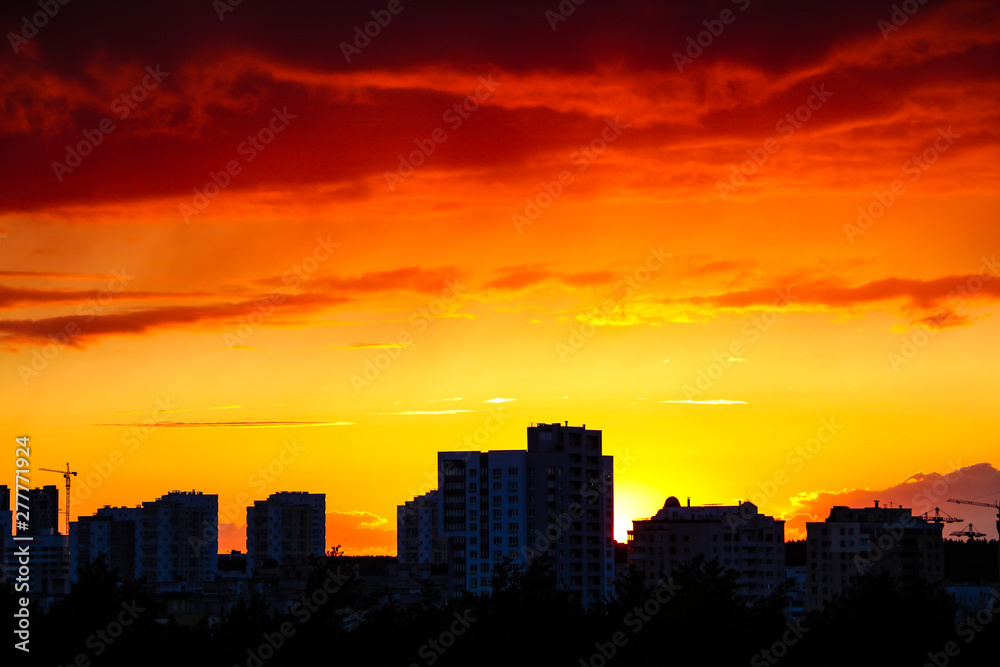 Beautiful stormy sunset over the city in dramatic colors.