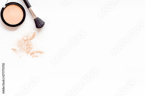 Brushes for make up, powder on white visagiste work desk background top view copyspace photo