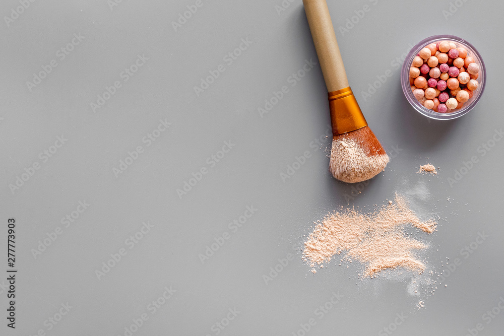 Fotografie Instruments for make up with brushes, blusher on gray background top view mock u