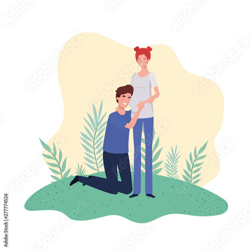 pregnant woman with husband standing in landscape