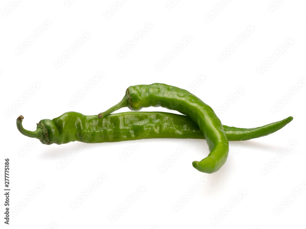 There are two green bitter peppers. On a white background. Still life. Close-up. There are two green bitter peppers. On a white background. Still life. Close-up.