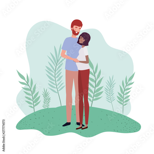 pregnant woman with husband standing in landscape