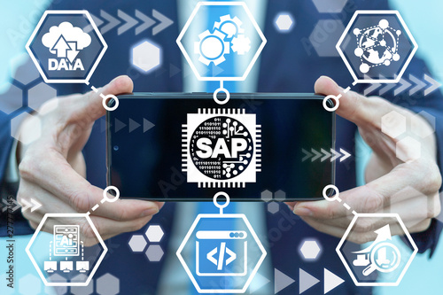 Man holding smartphone with sap micro chip icon on screen. SAP - Business process automation software. ERP enterprise resources planning system concept. photo