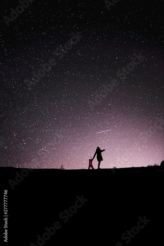 Finland, Kuopio, mother and daughter watching shooting star photo