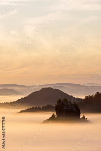 Germany, Saxony, Elbe Sandstone Mountains, view to the mountain Winterstein from the Gleitmannshorn at sunrise photo