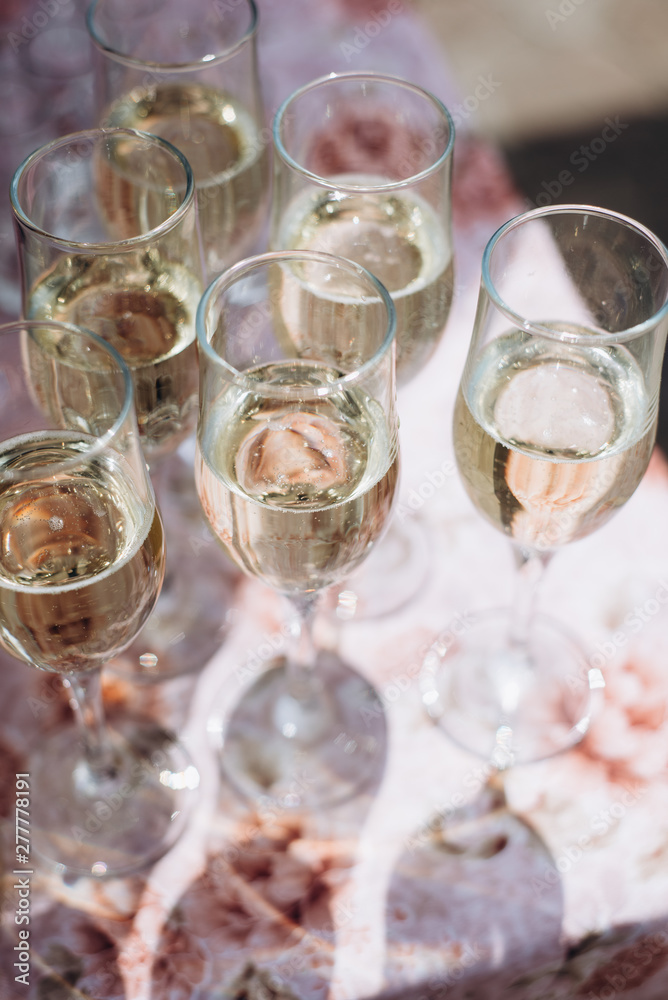 Vertical image of lot of wine glasses with cool delicious champagne or white wine. Party and holiday celebration concept Vertical image of lot of wine glasses with cool delicious champagne or white wine. Party and holiday celebration concept