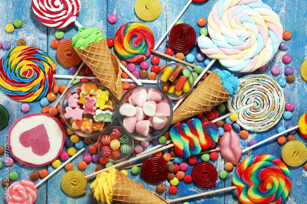 candies with jelly and sugar. colorful array of different childs sweets and treats on blue candies with jelly and sugar. colorful array of different childs sweets and treats on blue