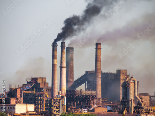 Air pollutants emissions     central composition. Toxic smoke of air pollutants  released into the atmosphere by chimney smoking stack  pollutes the environment  causing the greenhouse effect.