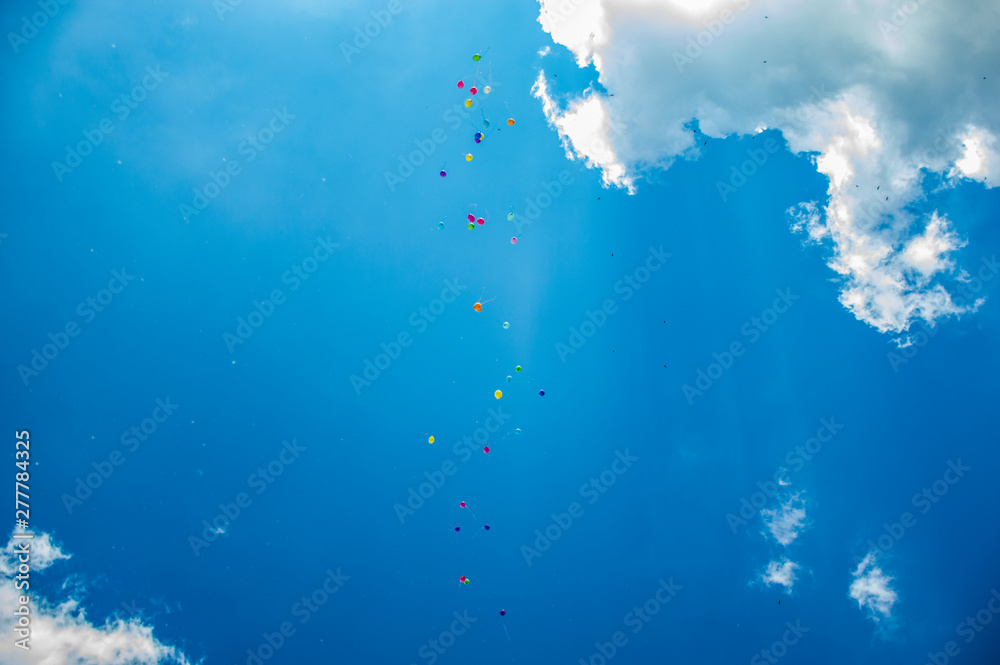Multicolor ballons in the summer blue sky with clouds Multicolor ballons in the summer blue sky with clouds