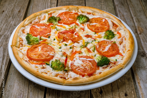 Pizza with vegetables vegetarian on the wooden background