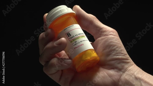 Man holding a prescription pill bottle