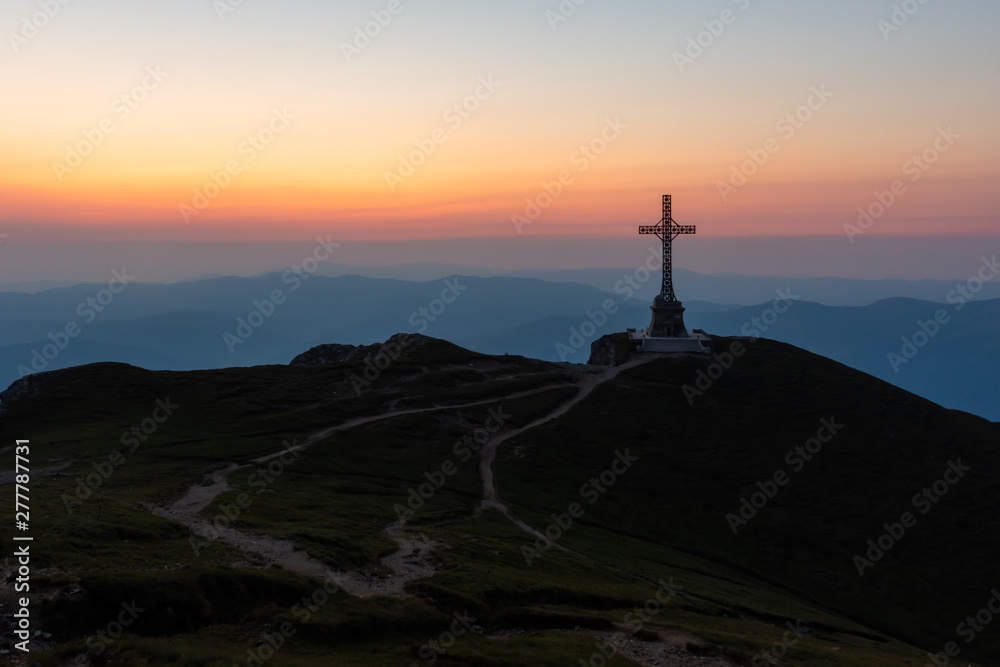 Heroes' Cross on Caraiman Peak at early dawn, Bucegi mountains, Romania