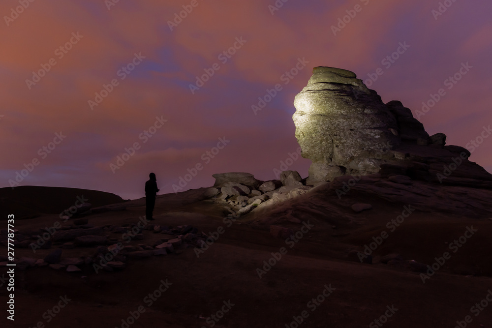 The Sphinx in the Bucegi Natural Park at night, illuminated by flashlight.