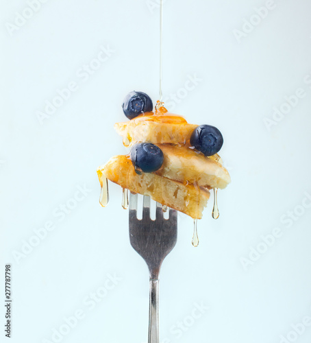 Composition of sweet dessert with strawberry and blueberries flavored by honey on white background photo