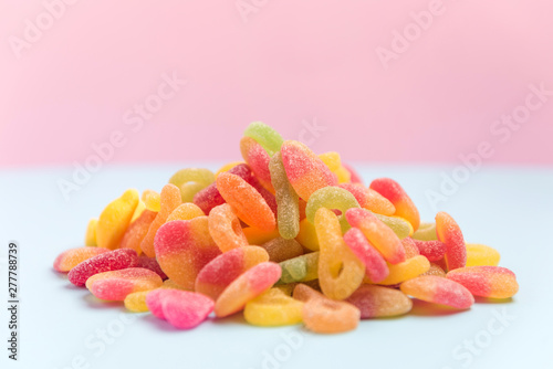 Pilw of sugary candies isolated on a pink background