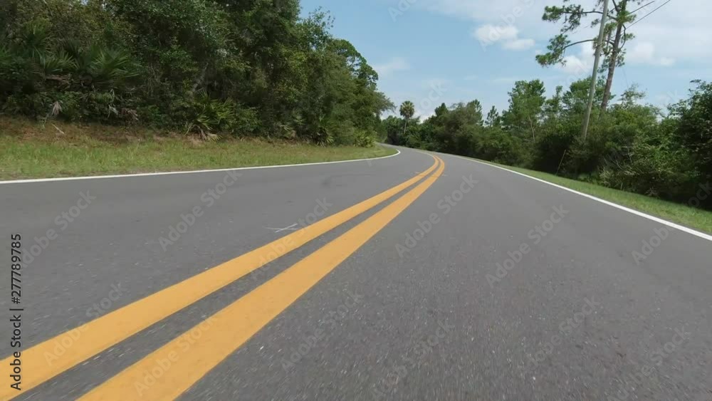 In a vehicle's point of view, going around corners and going straight down the street in a rural area in 4k. In a vehicle's point of view, going around corners and going straight down the street in a rural area in 4k.