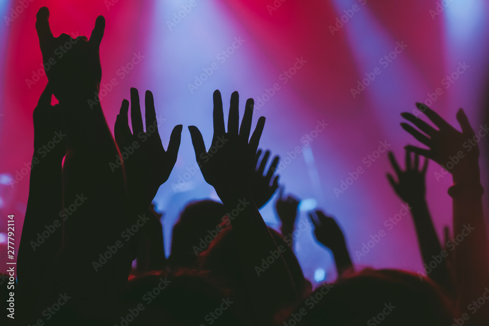 Hands of the crowd raised up at music concert