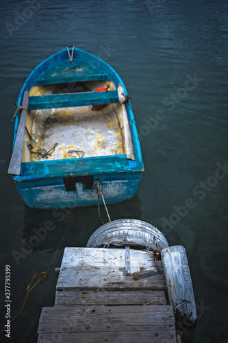 Small blue wooden rowing fisherman boat