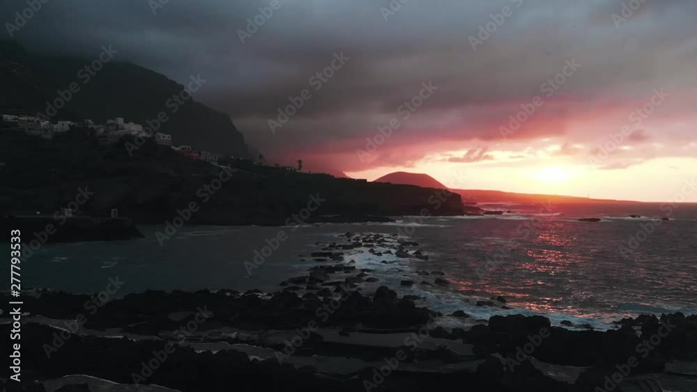 Aerial view - sunset near the town of Garachico, a small bay and the picturesque Spanish city on the shores of the Atlantic Ocean. Cinematic flight. Aerial view - sunset near the town of Garachico, a small bay and the picturesque Spanish city on the shores of the Atlantic Ocean. Cinematic flight.