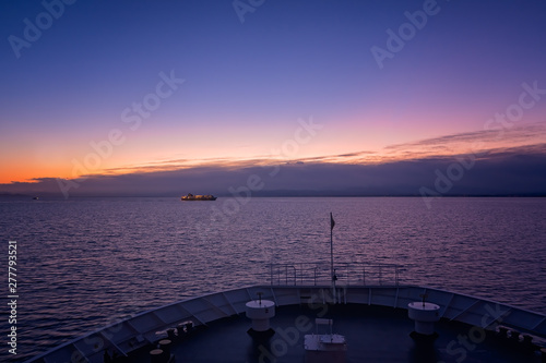 Front of a large passenger ferry sailing at dawn