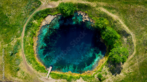  Aerial view from the drone of the landscape of blue mineral lake with clear water. Russia, Samara region, Blue lake.