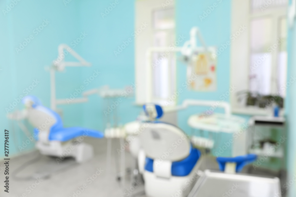 Blurred view of dentist's office with chairs and professional equipment Blurred view of dentist's office with chairs and professional equipment