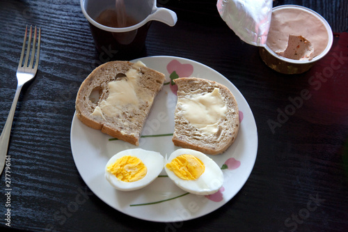 Healthy Polish breakfast hard boiled egg, cheese spread bread and butter coffee. Zawady Poland