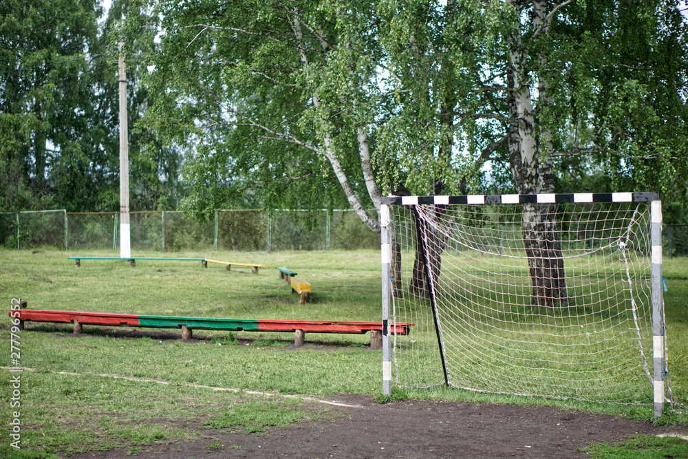Old football goal in a street stadium in a country children's camp. Training base Old football goal in a street stadium in a country children's camp. Training base