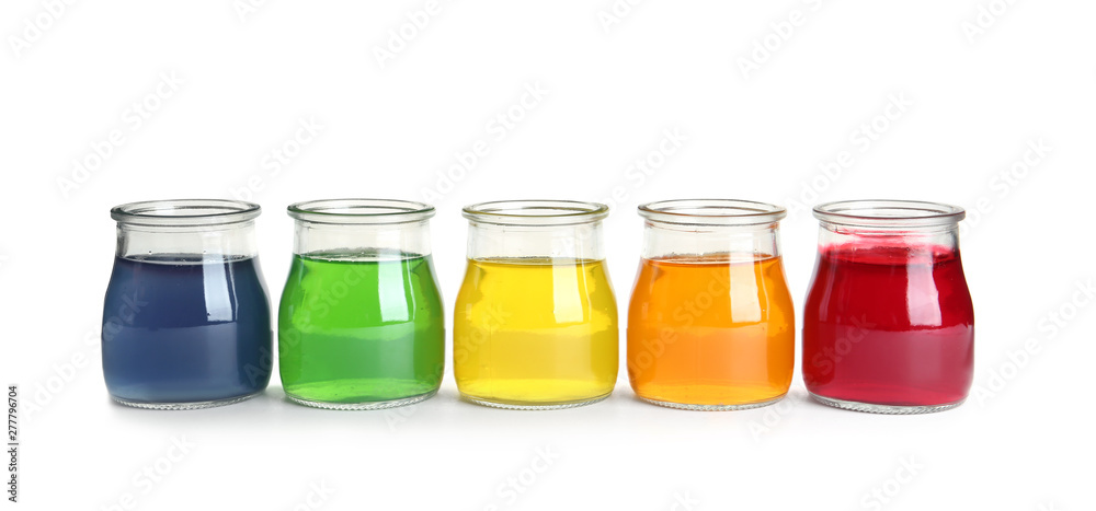 Tasty jelly desserts in glass jars on white background Tasty jelly desserts in glass jars on white background
