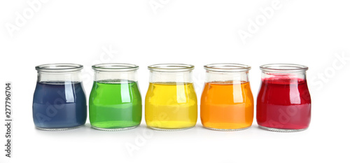 Tasty jelly desserts in glass jars on white background