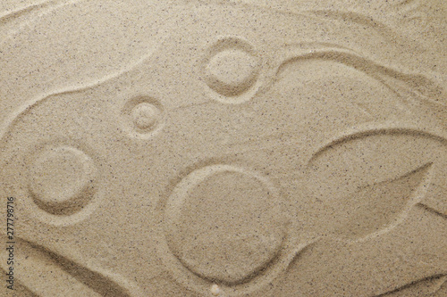 Patterns drawn on yellow sand