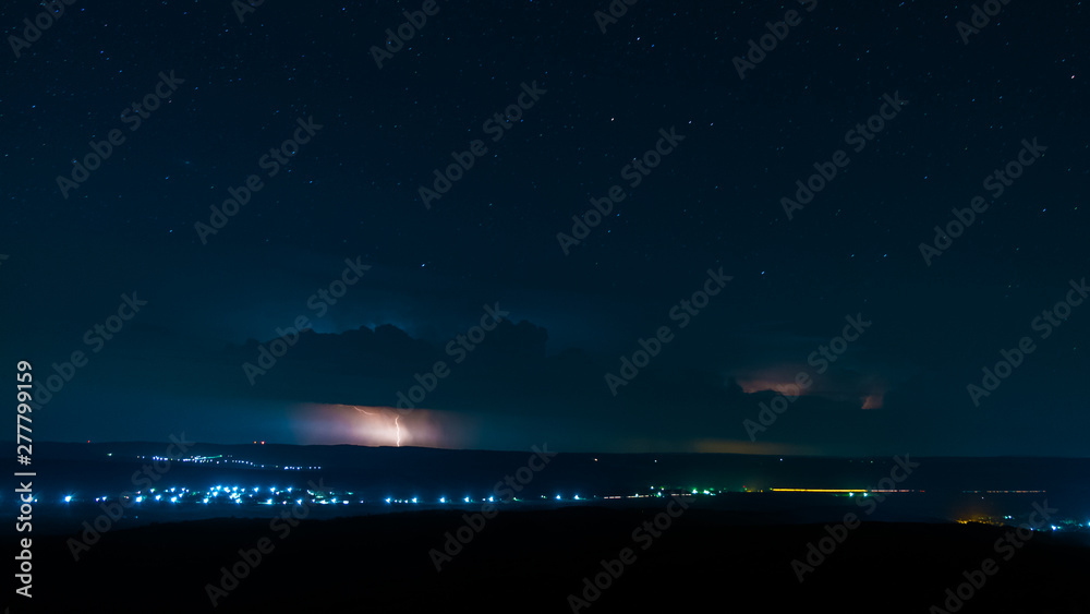 lightning on a nocturnal background, full of stars